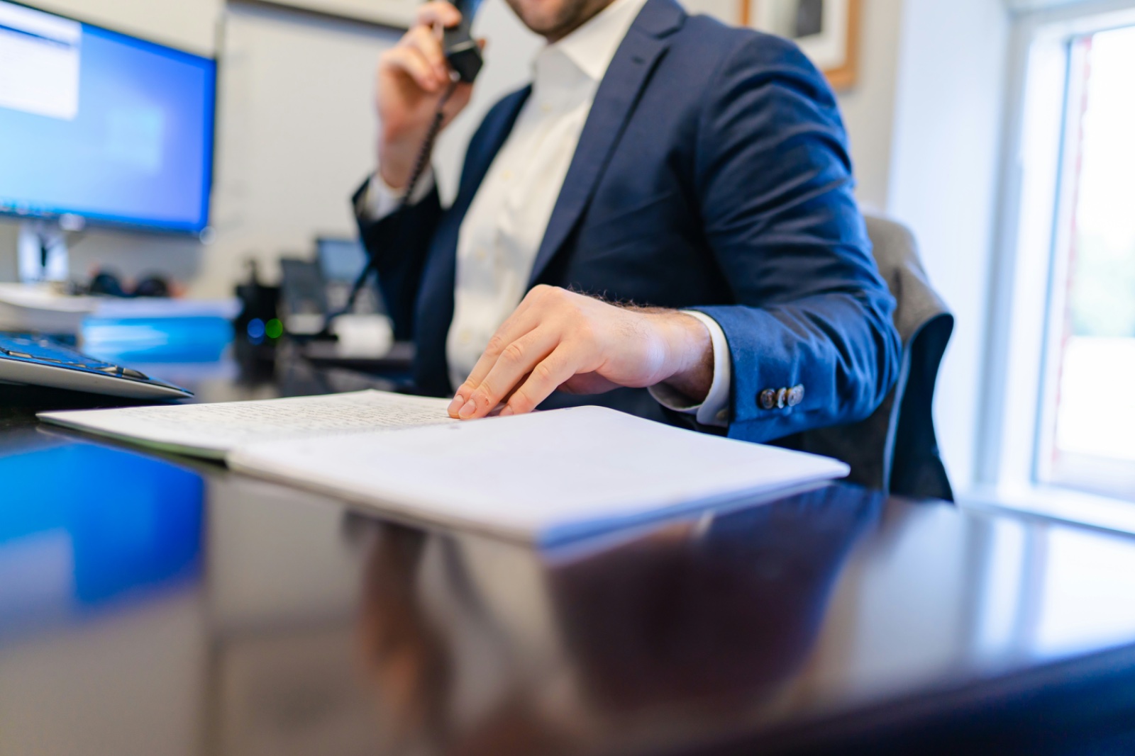 A professional reviewing documents during a working session